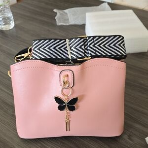 Elegant Pink Crossbody Bag with Black and White Strap
